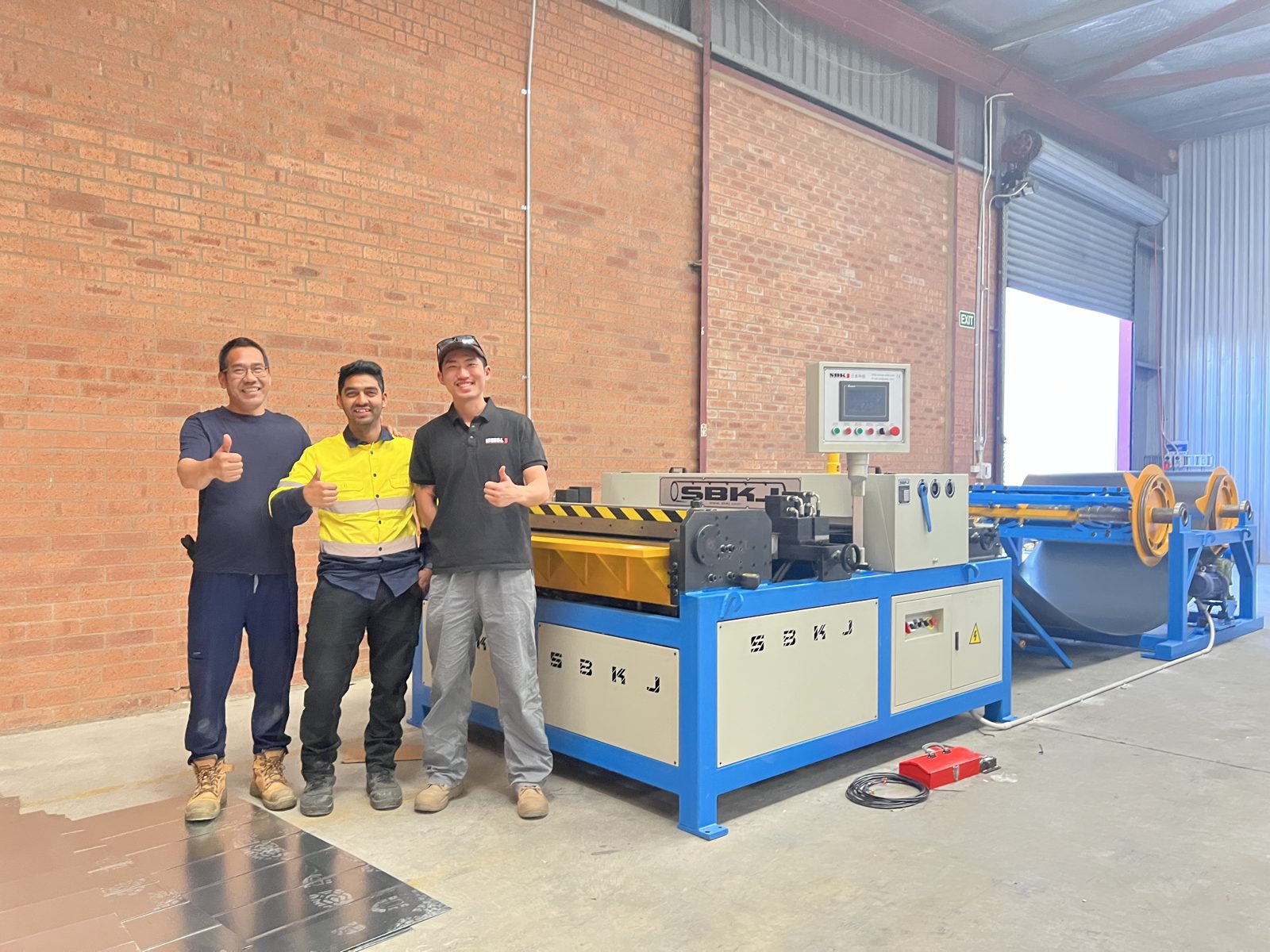 Airtemp team and Taokron engineer in front of the coil line